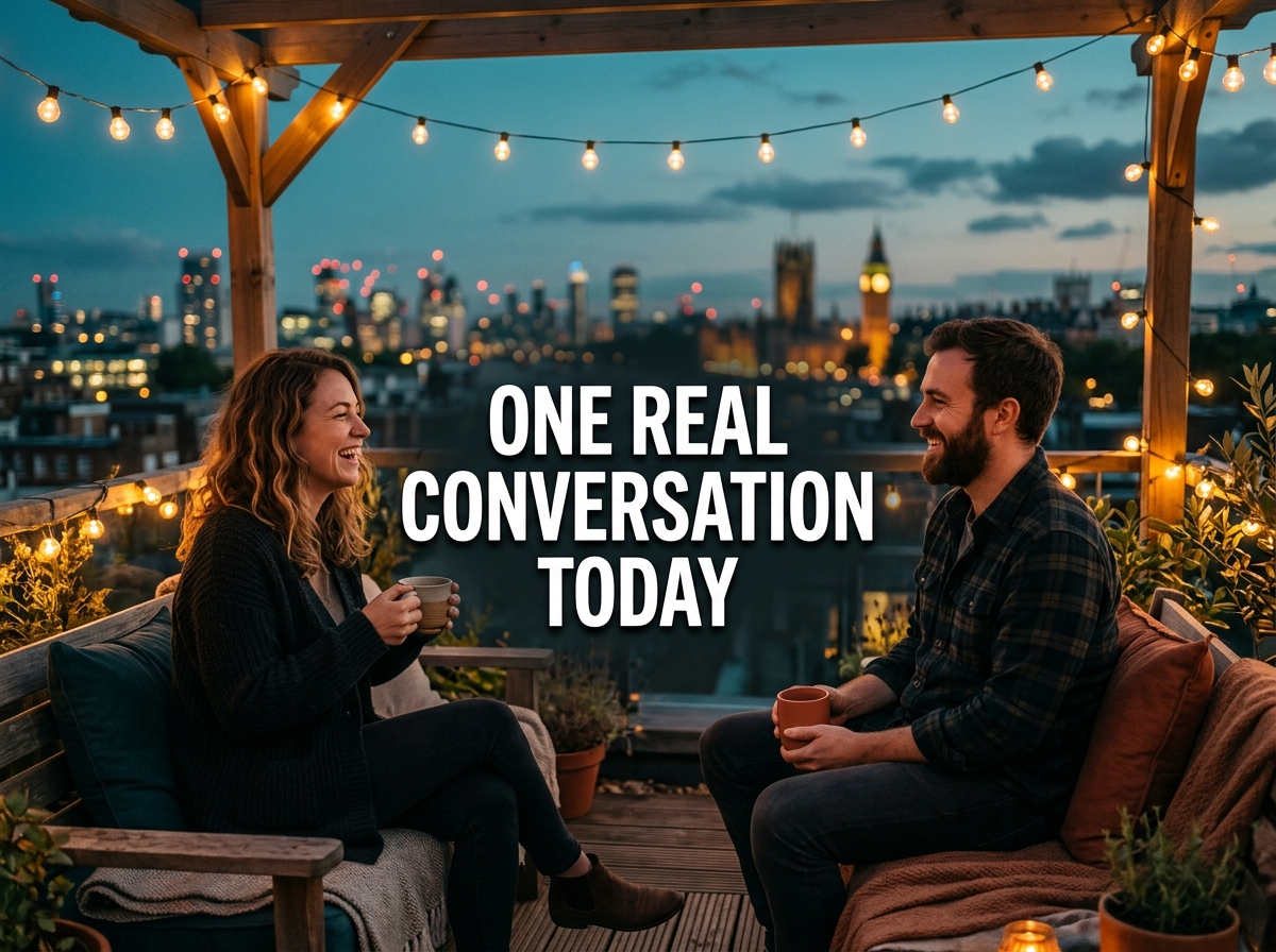 Two friends talking over tea on a rooftop at dusk with the text One Real Conversation Today.